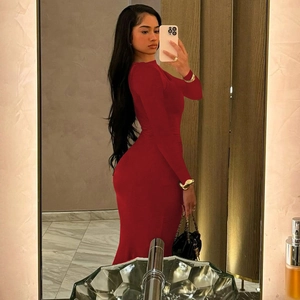 Detail view of the fitted long-sleeve burgundy dress showing side ruching and hip silhouette