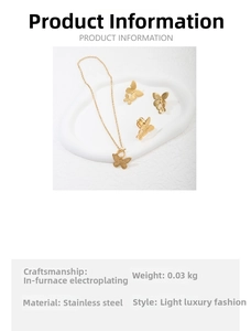 Detailed close-up of gold butterfly jewelry set featuring necklace earrings and ring