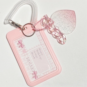 Close-up of pink glitter heart pendant with gradient acrylic chain on cloud ID card holder