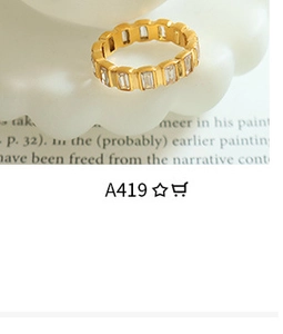 Detail of 18K gold plated ring with wave texture and rectangular crystal inlay