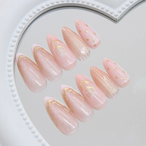 Pink press on nails with gold floral cat-eye tulip patterns in almond shape