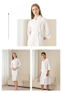 Detail view of white waffle weave bathrobe featuring soft cotton fabric and deep side pockets