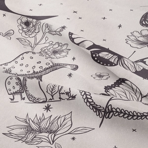 Macro shot of boho mushroom and floral print on white fabric texture for moon phase tapestry