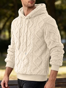 Detail shot of men's beige fleece hoodie featuring textured diamond quilted pattern