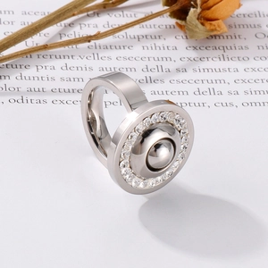 Detailed view of silver stainless steel ring with polished dome and zircon halo inlay