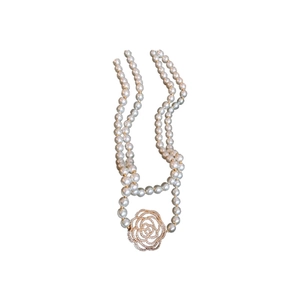 French retro pearl necklace featuring a golden zircon camellia pendant on a white background