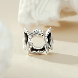 Macro view of 925 sterling silver rose and thorn bead with vintage oxidized finish
