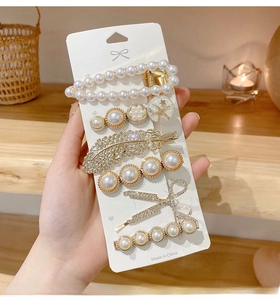 Set of six gold alloy hair clips featuring white faux pearls and sparkling rhinestones