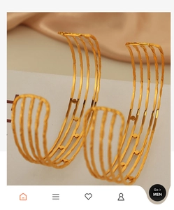 Detail view of 18K gold plated minimalist C-shape layered cuff bracelet on white stand