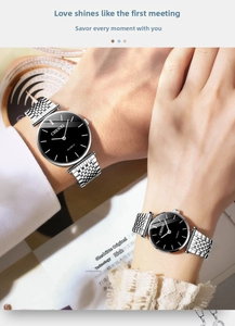 Close-up of silver steel mesh couple watches with minimalist black dial on wrist