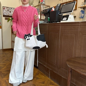 Detail of creative black and white cat-shaped tote bag with 3D ears and tail design