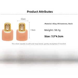 Detail view of large geometric resin earrings with crystals measuring 7.3cm by 4.5cm