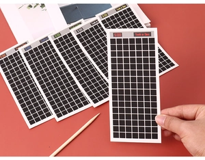 Close-up of Truth or Dare scratch cards with black grids on a vibrant red background