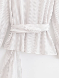 Close-up of women's striped shirt with waist tie detail and vertical black lines