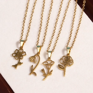 Detail of four 18k gold plated stainless steel necklaces with various floral pendant designs