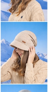 Detail of beige knit beanie with brim featuring leather patch and braided cable texture
