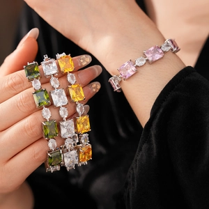Macro shot of colorful rectangular zircon bracelets with silver plating on black background