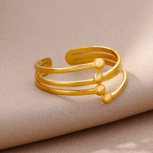 Detail of a 18k gold plated multi-layer spiral ring with round sphere ends on fabric