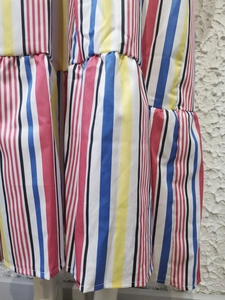 Detail shot of multi-color striped fabric with ruffled tiers and pleated texture