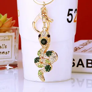 Close-up of snake keychain with sparkling green and white rhinestones and gold lobster clasp