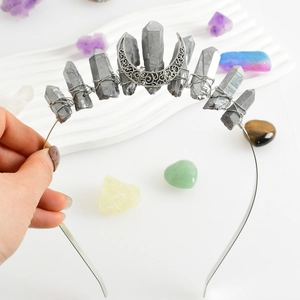 Silver crown headband with raw grey crystal pillars and an ornate crescent moon pendant