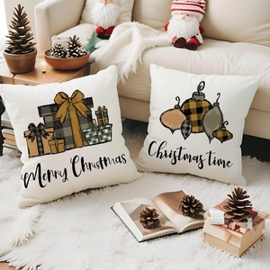 Close-up of linen Christmas pillowcases with festive gift box patterns on a white rug