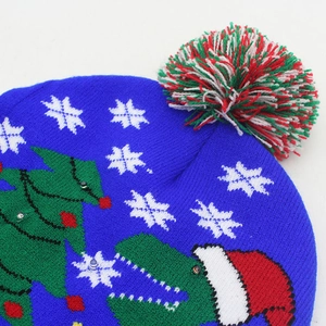 Close-up of blue knitted Christmas hat with colorful LED lights and pom-pom detail