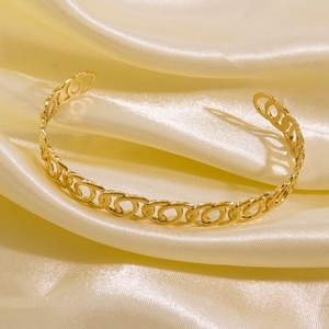 Close-up of a 14K gold-plated titanium steel bracelet with flat chain link texture