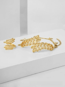Detailed close-up of gold-plated wheat leaf jewelry set with open ring and bracelet