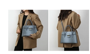 Detail of light blue crocodile pattern handbag with golden twist lock and shoulder strap