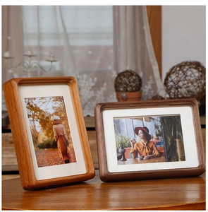 Macro detail of rounded corners on walnut and light wood frames in a home setting
