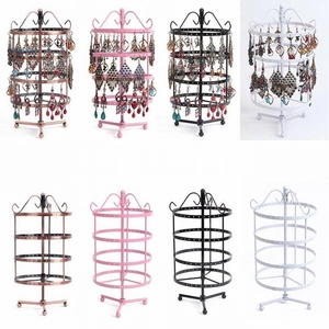Detail of multi-tier rotating metal earring stand in bronze, pink, black, and white colors