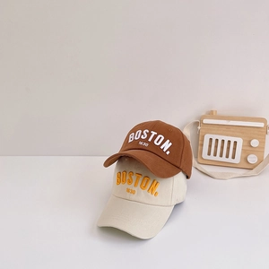 Close-up of brown and beige kids' cotton baseball caps with Boston 1630 embroidery