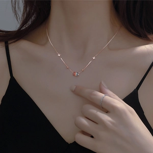 Elegant geometric silver necklace and ring set on model wearing black dress