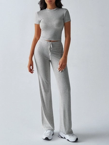 Detail view of grey two-piece set featuring short sleeve crop top and drawstring flared pants