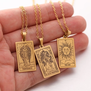 Three gold tarot card necklaces featuring Sun, Priestess and Temperance on dainty chains