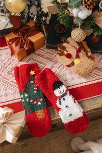 Christmas coral fleece socks with elk and snowman patterns in a cozy festive setting