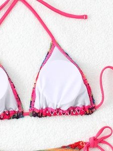 Detail of pink halter bikini top with knit borders and round padded white inner lining