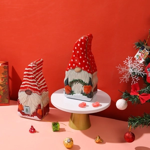 Christmas tin box set with gnome designs on festive red background for holiday candy storage