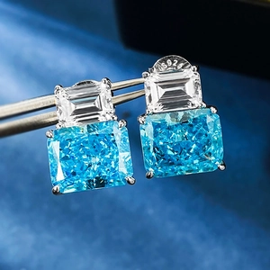 Macro view of S925 silver stud earring with emerald-cut blue stone and s925 hallmark