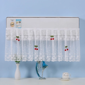 Close-up of white lace air conditioner cover with embroidered daisies and cherry accents