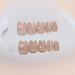 Cat eye press-on nails with 3D pink flowers and pearl accents in short T-ballet shape