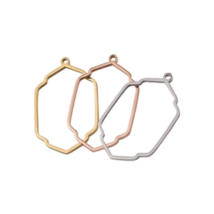 Macro view of octagonal pendant frames in gold, rose gold and silver stainless steel
