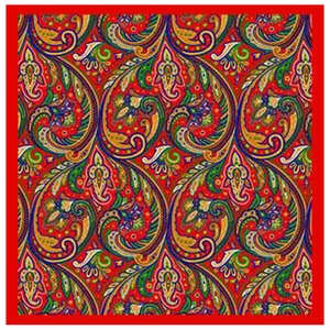 Flat lay of red paisley silk scarf showing intricate ethnic floral patterns and details
