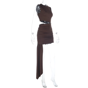 Detail of coffee brown sleeveless halter dress featuring waist cutout and draped pleats