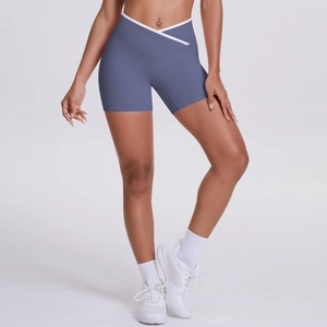 Detail view of high-waisted yoga shorts with crossover V-waist and contrast trim