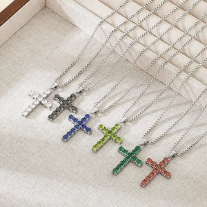 Elegant stainless steel cross necklaces with colorful zircon stones in a neat display