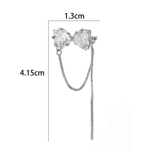 Macro shot of silver zircon butterfly ear cuff with long tassel chain detailing