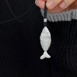 Articulated silver fish pendant necklace in S925 sterling silver on black woven cord