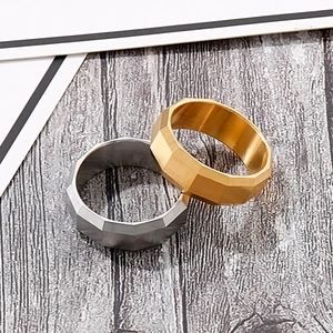 Detailed view of gold and silver brushed stainless steel rings with geometric facets